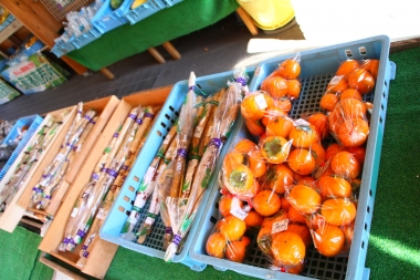 地元で取れた野菜なども販売されていた。綺麗に色づいた柿！　